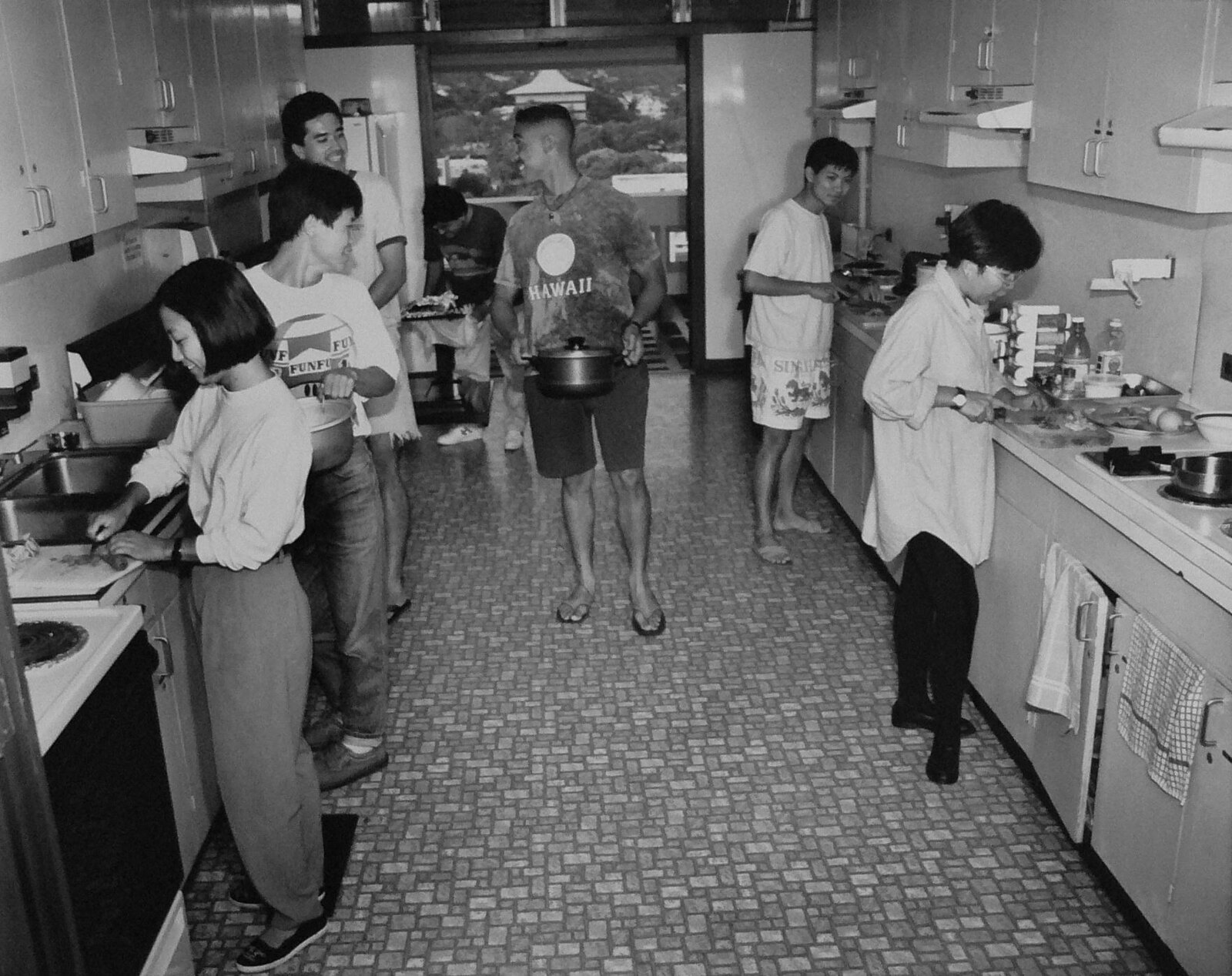 Students cooking food in Hale Manoa dorms, black and white photo